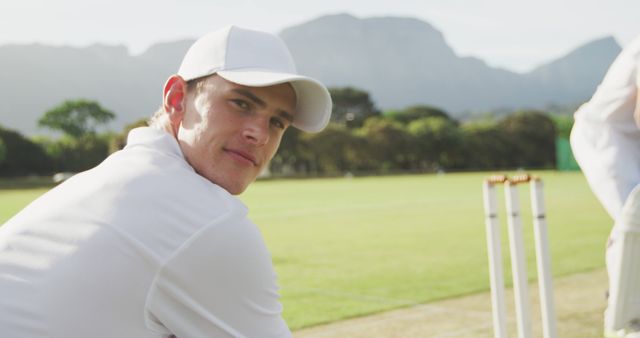 Portrait of happy caucasian male cricket player wearing cap on field, copy space - Download Free Stock Photos Pikwizard.com