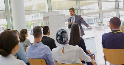 Motivational Business Speaker Engaging Diverse Audience at Seminar - Download Free Stock Images Pikwizard.com
