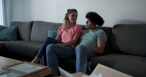 Young Couple Relaxing on Sofa at Home