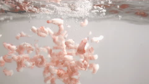Peeled Shrimps Floating in Water Mid-Splash