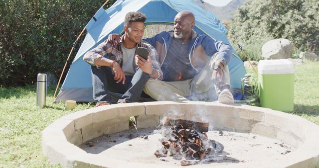 Father and Son Enjoying Outdoor Camping Trip Beside Campfire - Download Free Stock Images Pikwizard.com