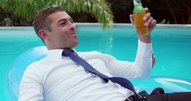 Businessman Relaxing on Pool Float with Beer - Download Free Stock Images Pikwizard.com