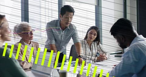 Business team collaborating on sales analytics, lead presenting growth charts in boardroom