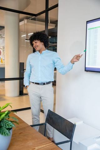 Professional Presenting Data on Screen in Modern Office