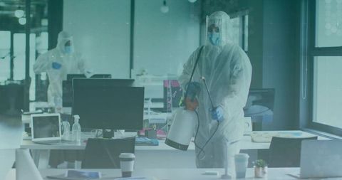 Sanitization expert disinfecting office with protective gear