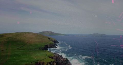 Aerial coastal meadow with grazing sheep on rugged cliffs meeting deep blue ocean horizon