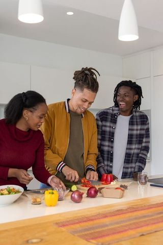 Friends Preparing Fresh Salad on Modern Kitchen Island, Casual Home Cooking Moment