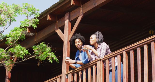 Young Couple Relaxing on Wooden Balcony Enjoying Morning Coffee - Download Free Stock Images Pikwizard.com