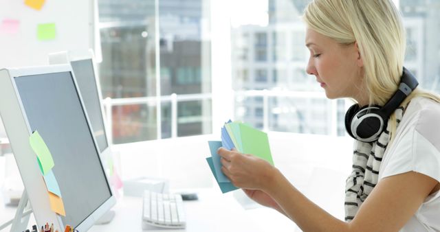 Woman Choosing Color Swatches in Modern Office Environment - Download Free Stock Images Pikwizard.com