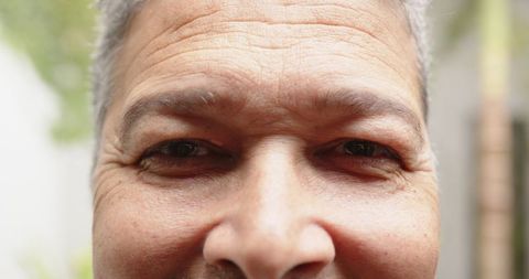 Mature man gazing in garden reflecting serene thoughts