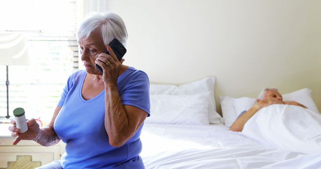 Elderly Woman Consulting Over Phone Holding Medication in Bedroom - Download Free Stock Images Pikwizard.com