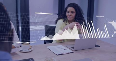 Leading woman guiding collaborative meeting with laptop and data visualizations