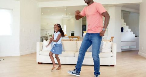 Father and Daughter Dance Playfully in Living Room