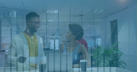 Colleagues Collaborating with Financial Data Overlay at Modern Office