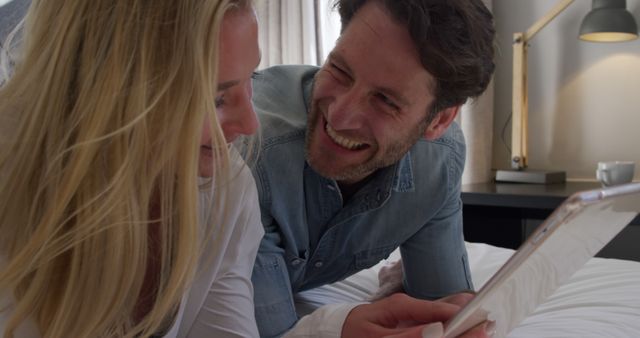 Happy Couple Relaxing Together Using Tablet in Cozy Bedroom - Download Free Stock Images Pikwizard.com