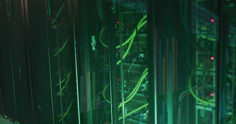 Rack-mounted servers glowing with green leds and yellow network cables in data center