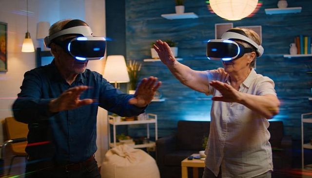 Senior couple exploring virtual reality at home with vr headsets and joyful interaction