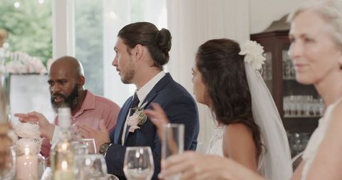 Joyful Wedding Reception with Guests Engaging at Elegantly Set Table