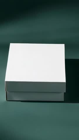 Orbiting white packaging box on green tabletop for minimalist product presentation