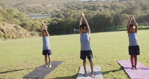Boys Practicing Yoga in Mountain Pose Outdoors on Sunny Day