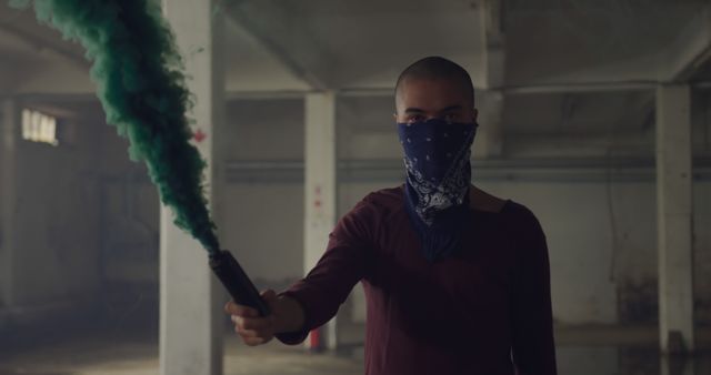 Mysterious Person Holding a Green Smoke Bomb in Abandoned Warehouse - Download Free Stock Images Pikwizard.com