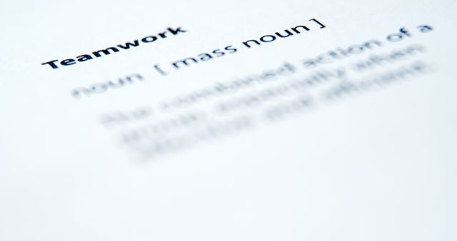 Close-up view of the word 'teamwork' and its definition in a dictionary, focusing on the text. Perfect for use in educational materials, articles about collaboration and teamwork, or blogs about language and definitions.