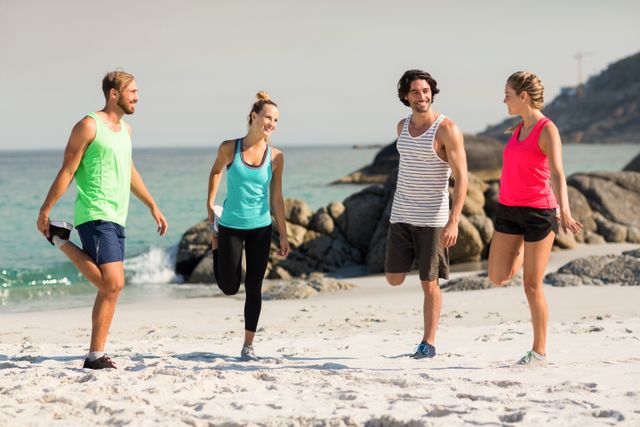 Group of friends stretching and exercising on a sunny beach. Ideal for promoting healthy lifestyles, fitness programs, outdoor activities, and summer fun. Perfect for use in advertisements, social media posts, and wellness blogs.