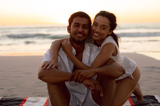 Portrait of young couple embracing each other on the beach
