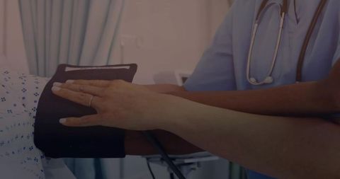 Nurse Checking Patient's Blood Pressure with Equipment in Hospital Ward