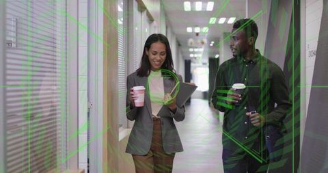 Professionals Discussing Work in Office Hallway with Tablets