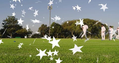 Cricket team running and standing on sunlit grassy pitch with starburst overlay