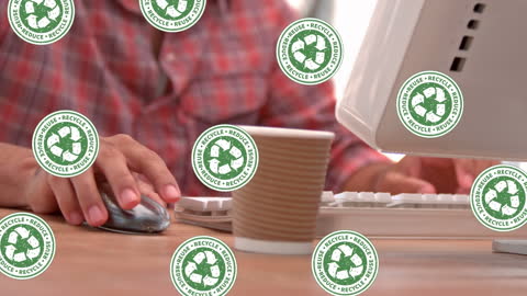 Animated Recycling Icons Overlay on Typing Man in Office