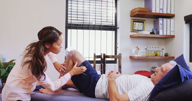 Physiotherapist Treating Senior Man's Knee in Clinic - Download Free Stock Images Pikwizard.com