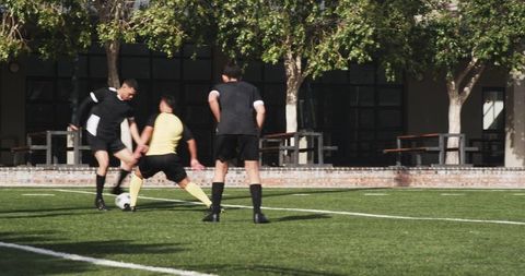 Teen soccer players practicing energetic drills on school field