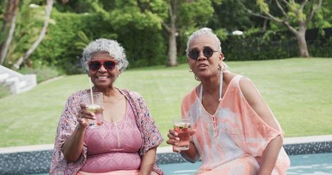 Senior Women Enjoying Leisure by Poolside in Summer