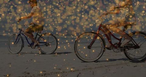 Couple Cycling on Beach with Sparkling Light Effect