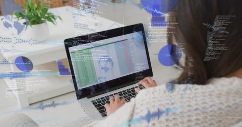 Mid-adult korean woman working on laptop analyzing spreadsheet and code with charts and graphs