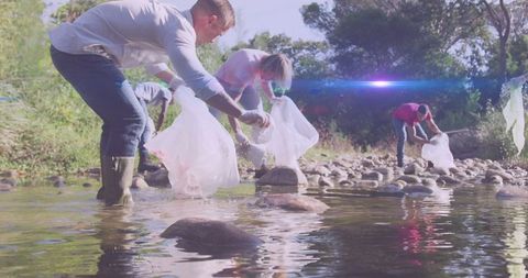Diverse Group Collecting Waste in River for Conservation Effort - Download Free Stock Images Pikwizard.com