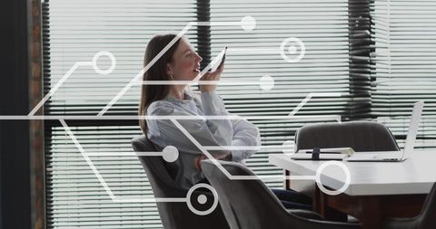 Businesswoman Using Smartphone with Digital Circuit Overlay in Office
