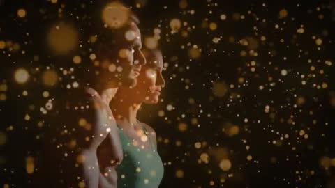 Athletic couple posing in profile with warm studio lighting and drifting gold bokeh