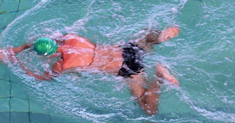 Fit Swimmer in Action Practicing Breaststroke in Pool