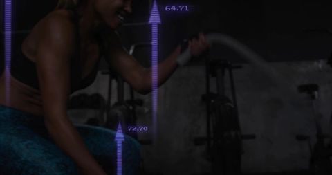 Athletic woman swinging battle ropes in gritty gym with purple performance readouts