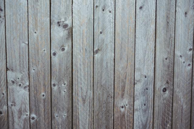 Weathered wooden plank wall background showing natural grain and texture. Ideal for use in rustic design projects, website backgrounds, or as a backdrop for text and graphics. Perfect for conveying a vintage or natural aesthetic in various creative projects.
