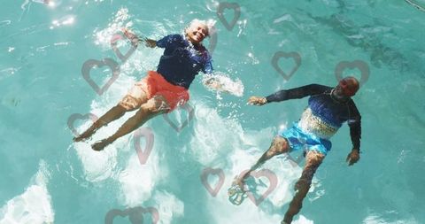 Senior Couple Relaxing Together in Home Pool with Heart Overlays