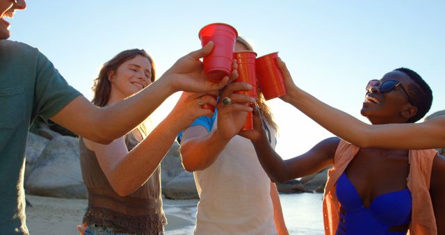 Friends Enjoying Beach Party Toasting with Red Cups at Sunset - Download Free Stock Images Pikwizard.com