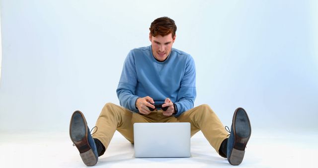 Young Man Enthusiastically Playing Video Games on Laptop with Game Controllers - Download Free Stock Images Pikwizard.com