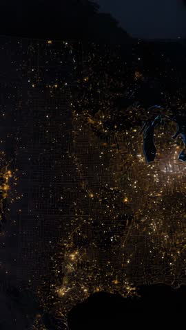 Vertical video panning and zooming over nighttime US map showing city lights grid and Great Lakes gl