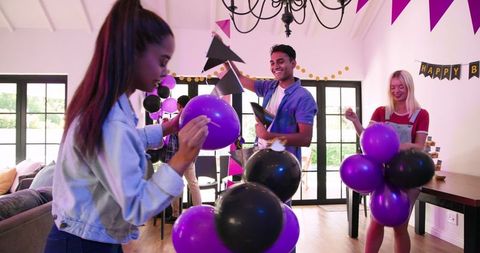 Friends Tidying Up After Lively Birthday Party Celebration