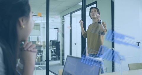 Engineer Presenting Code Diagram to Colleague in Modern Office