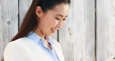 Smiling Professional Asian Businesswoman in White Blazer